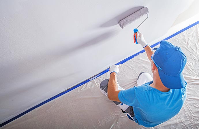 a painter painting interior of commercial space