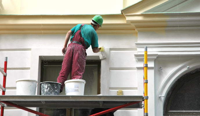 Person painting a wall
